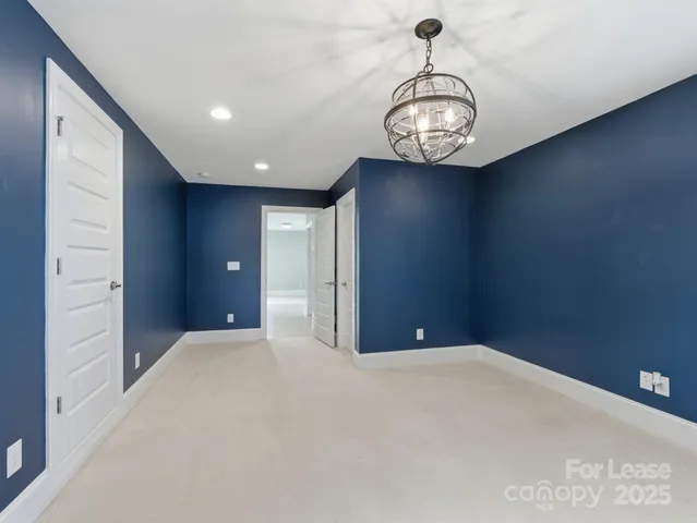 a view of a hallway with a chandelier fan