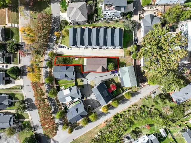 an aerial view of residential houses with city view