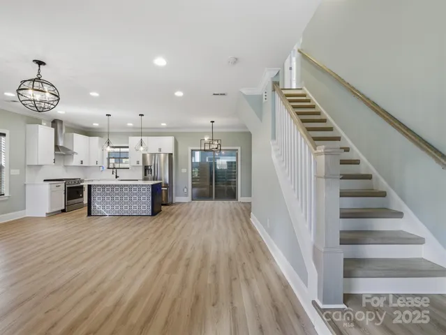 a view of kitchen with sink and refrigerator