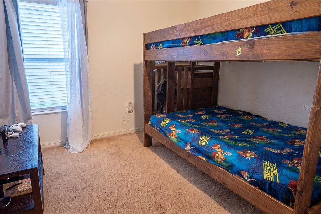4563 Orchard Grove Road St. Cloud, FL 34772 - Photo 30 of 51 a bedroom with a bed and a dresser