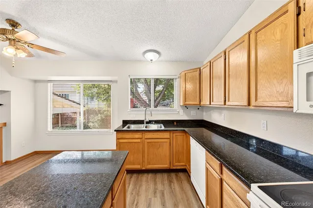 a kitchen with granite countertop a sink and a window