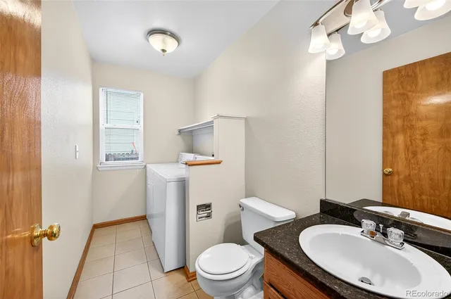 a bathroom with a sink toilet and a mirror