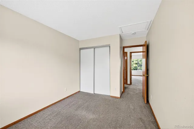 a view of a room with an empty space and a window