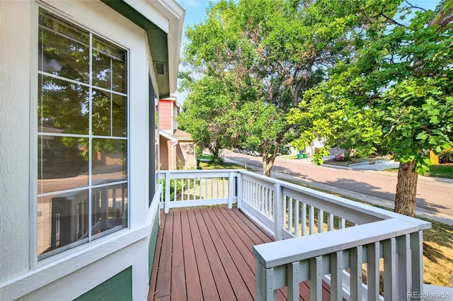 a view of balcony with wooden floor and fence