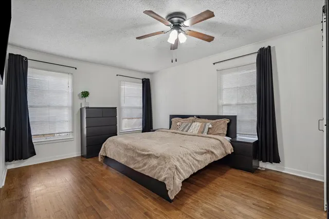 a large bedroom with a bed and a chandelier