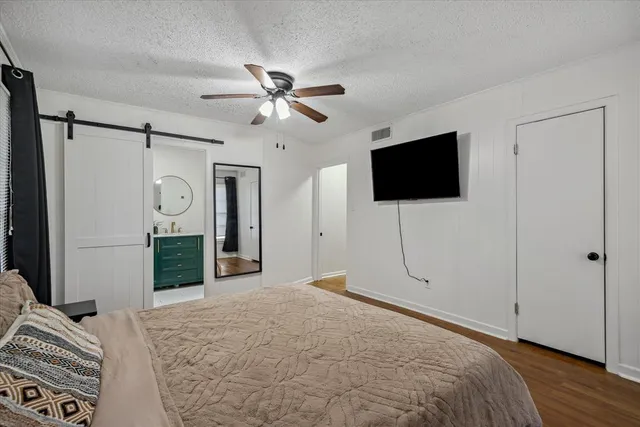 a bedroom with a bed and a flat screen tv
