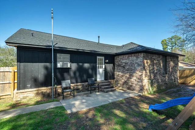a view of a house with yard and sitting area