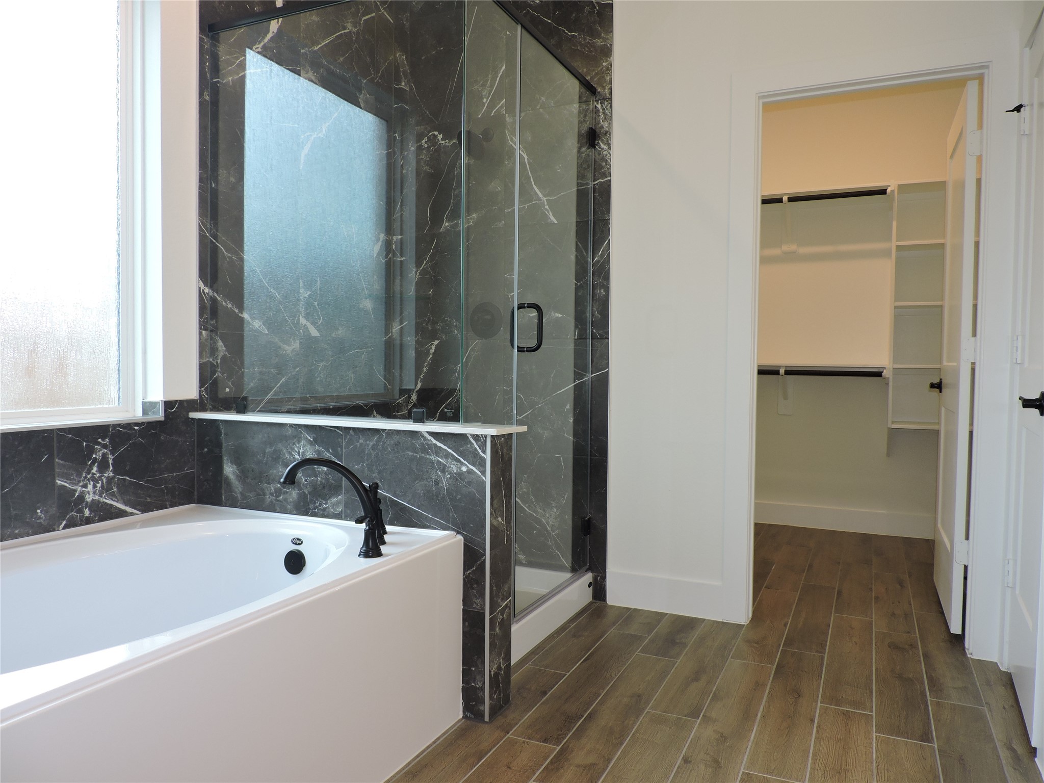 12853 Meadow Wind Way Conroe, TX 77302 - Photo 19 of 34 Primary Bath features large soaking tub, separate shower, Tile flooring and modern tile shower and tub surround.