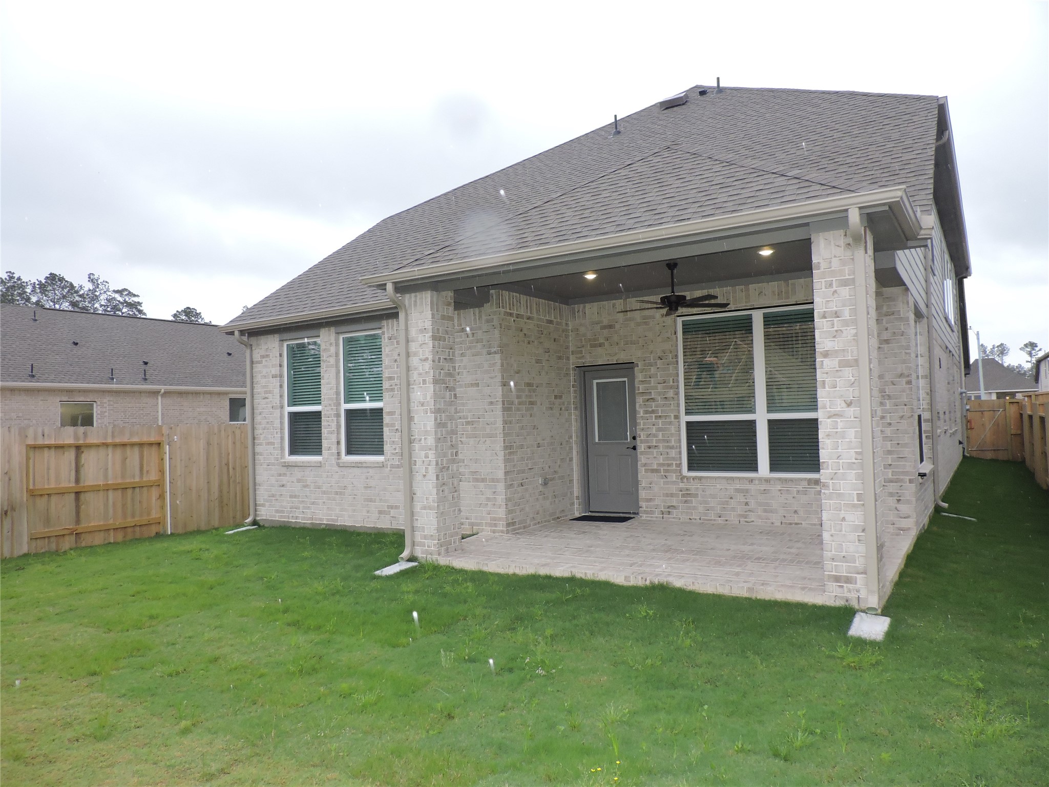 12853 Meadow Wind Way Conroe, TX 77302 - Photo 31 of 34 Large fenced back yard, sprinklers located in front and back.
large covered back patio with gas grill connection and outdoor ceiling fan.