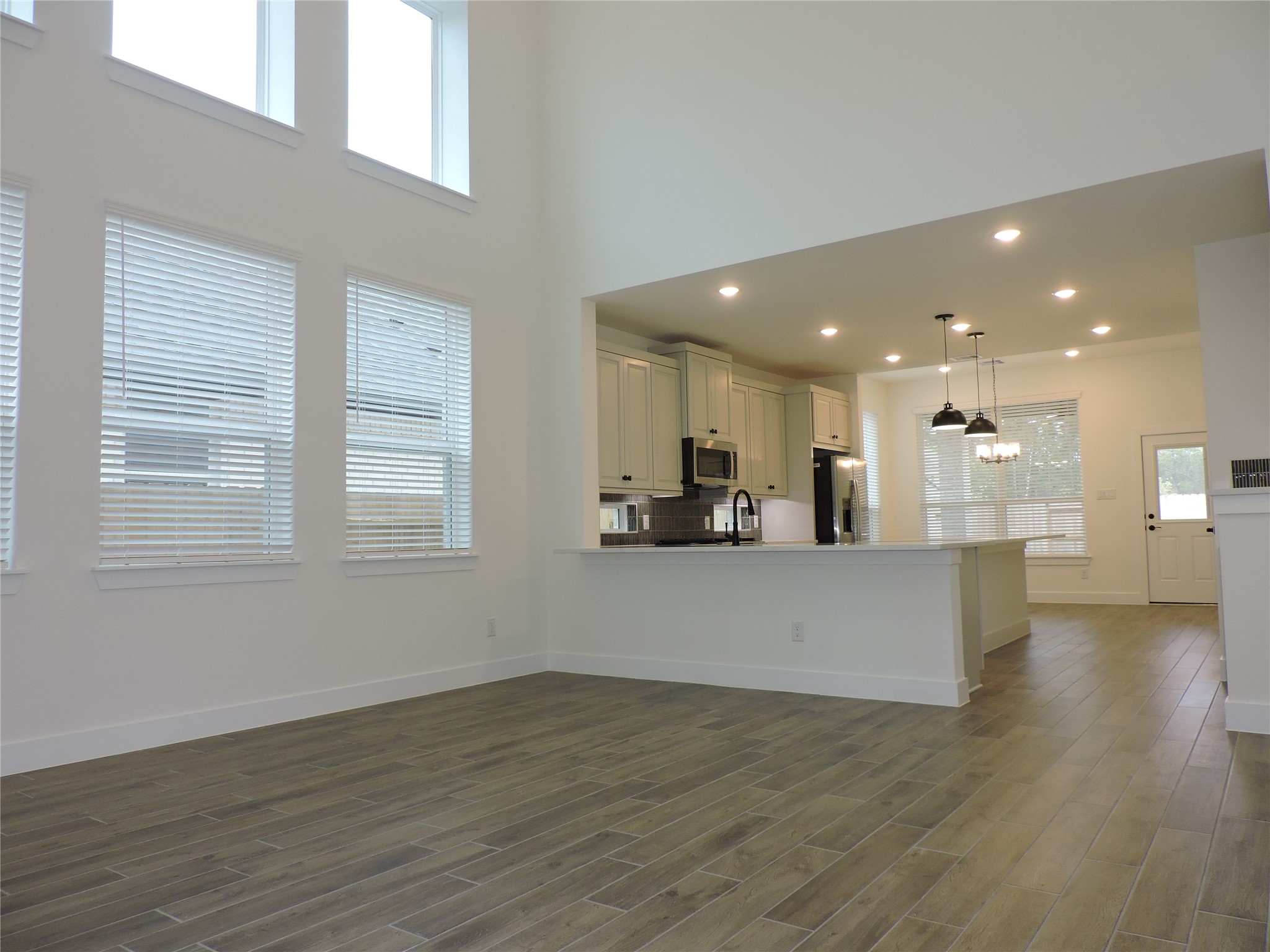 12853 Meadow Wind Way Conroe, TX 77302 - Photo 8 of 34 You will love this spacious open design. Living, Kitchen and Dining.