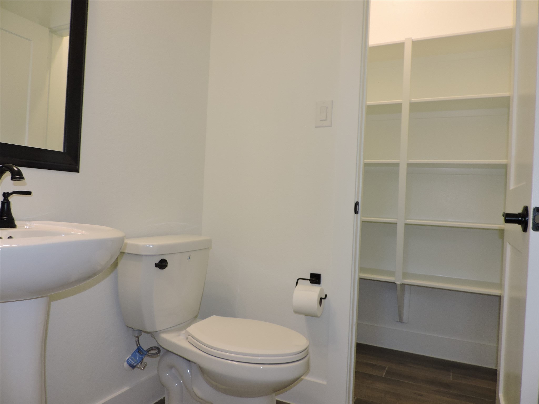 12853 Meadow Wind Way Conroe, TX 77302 - Photo 9 of 34 Half Bath downstairs with large storage closet.