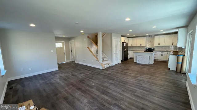 a bathroom with a granite countertop sink mirror vanity and toilet