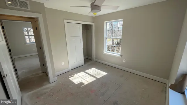an empty room with windows and entrance