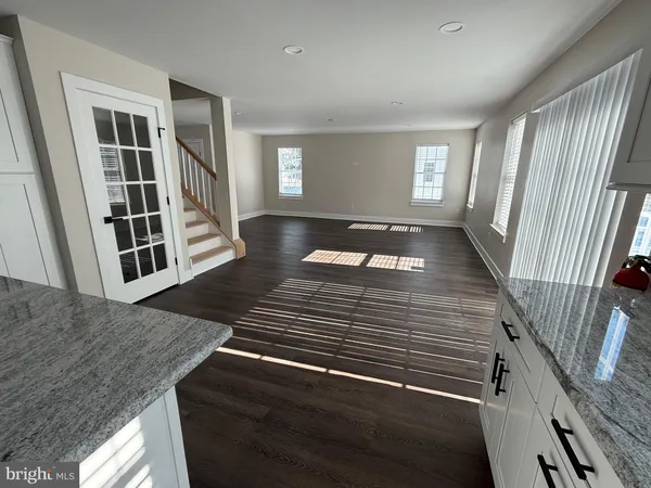 wooden floor in front of a living room with wooden floor