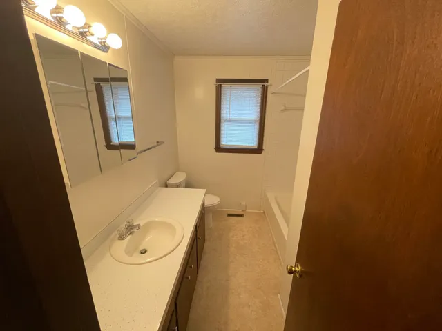 a bathroom with a sink and toilet