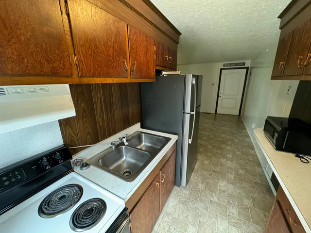 a kitchen with a stove and a refrigerator