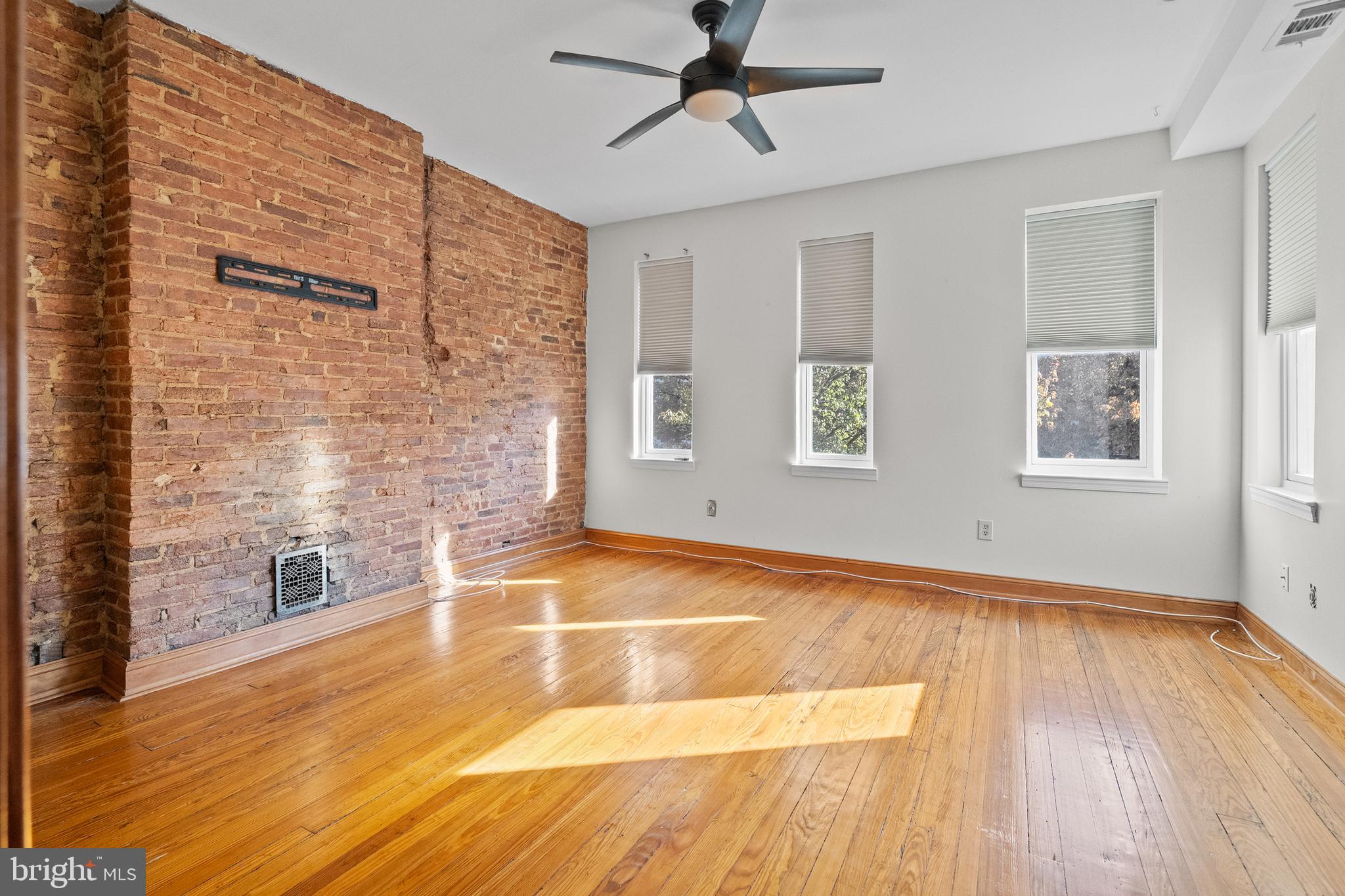 2200 East Baltimore Street Baltimore, MD 21231 - Photo 11 of 24 a view of an empty room with wooden floor and a window