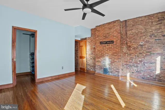 a view of an empty room with wooden floor