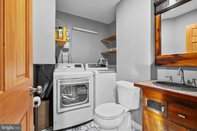 a bathroom with a sink toilet and mirror