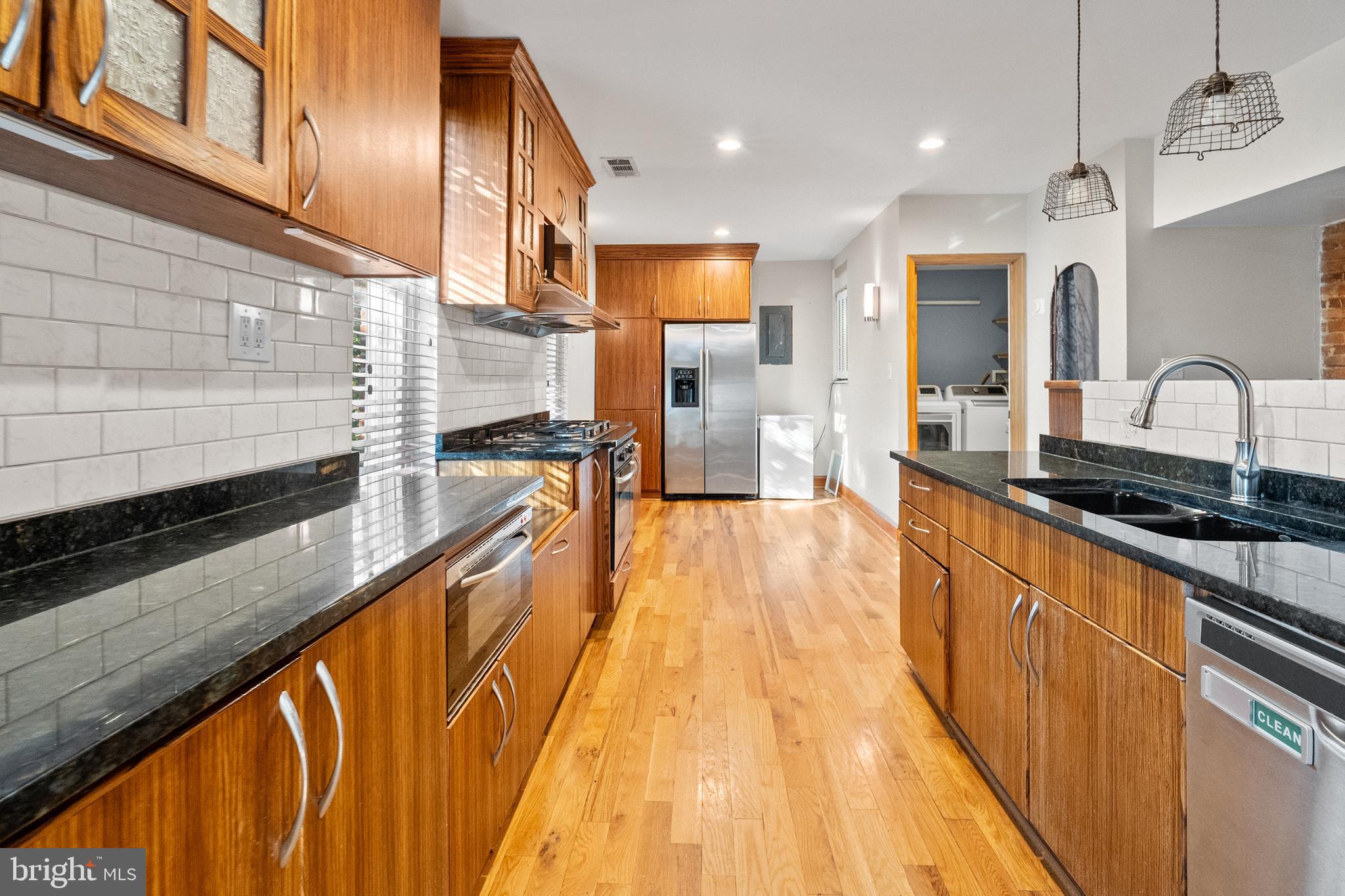 2200 East Baltimore Street Baltimore, MD 21231 - Photo 5 of 24 a view of a kitchen with kitchen island a large counter space a sink and stainless steel appliances