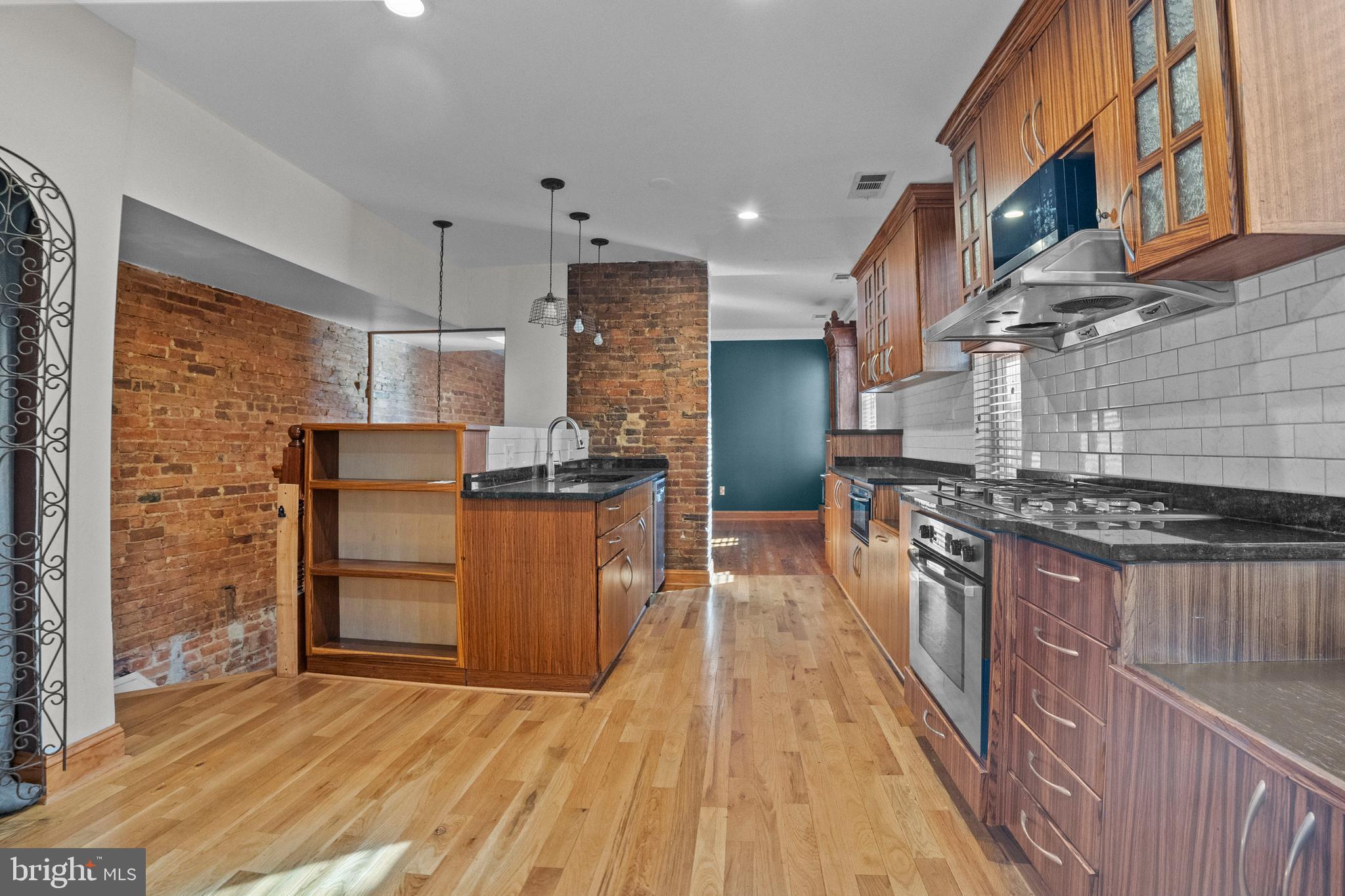 2200 East Baltimore Street Baltimore, MD 21231 - Photo 6 of 24 a kitchen with stainless steel appliances granite countertop a stove and a refrigerator