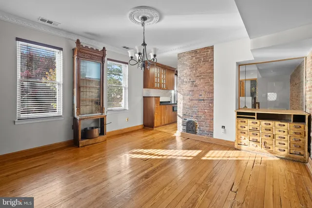 a view of empty room with a fireplace and wooden floor