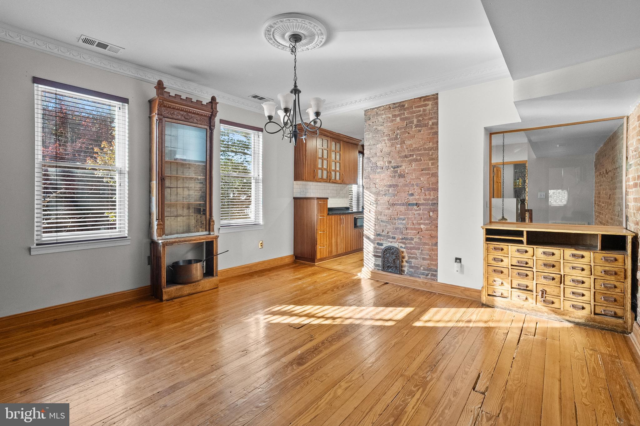 2200 East Baltimore Street Baltimore, MD 21231 - Photo 8 of 24 a view of empty room with a fireplace and wooden floor