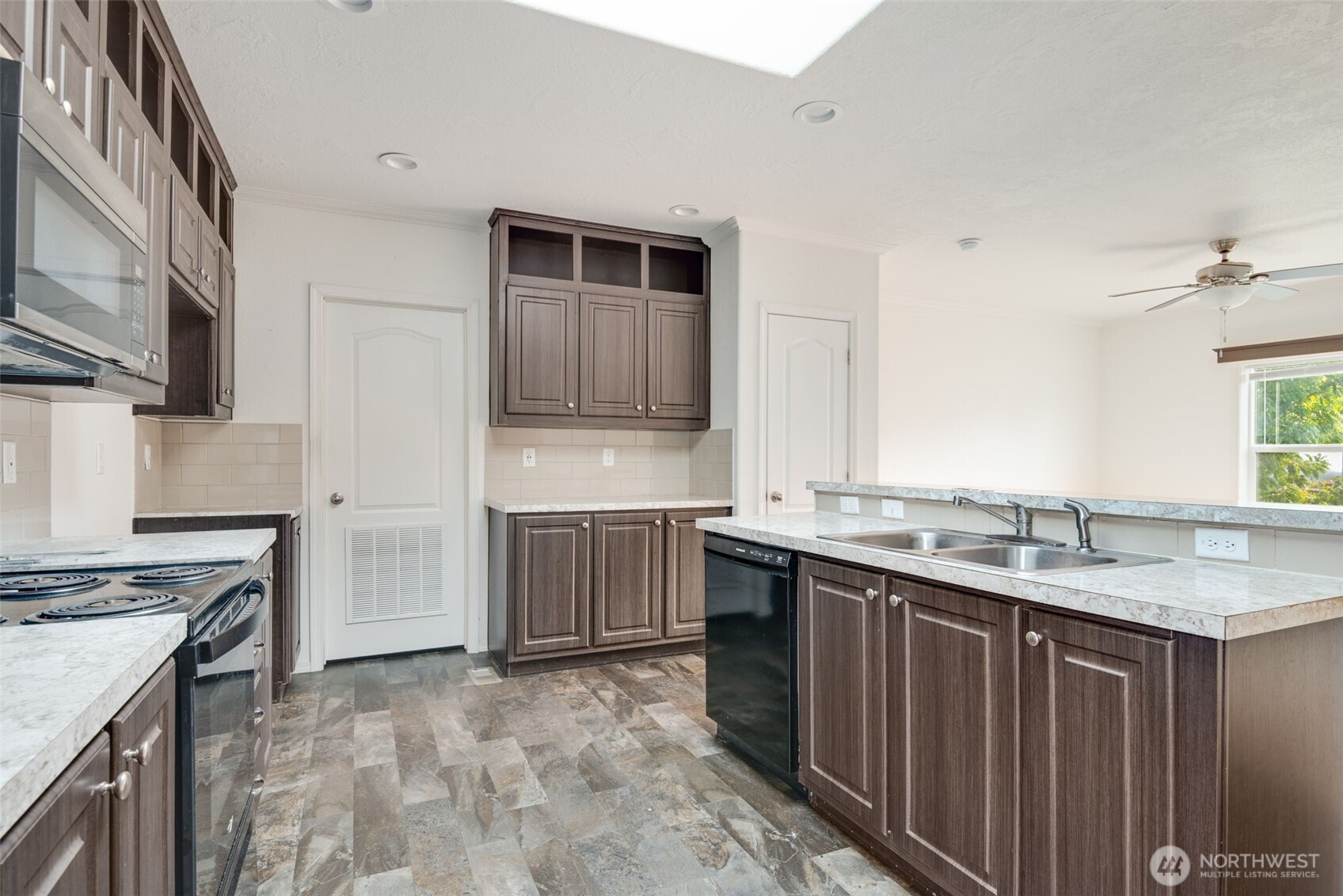 4322 Ocean Beach Highway Longview, WA 98632 - Photo 17 of 40 a kitchen with a sink stove and cabinets