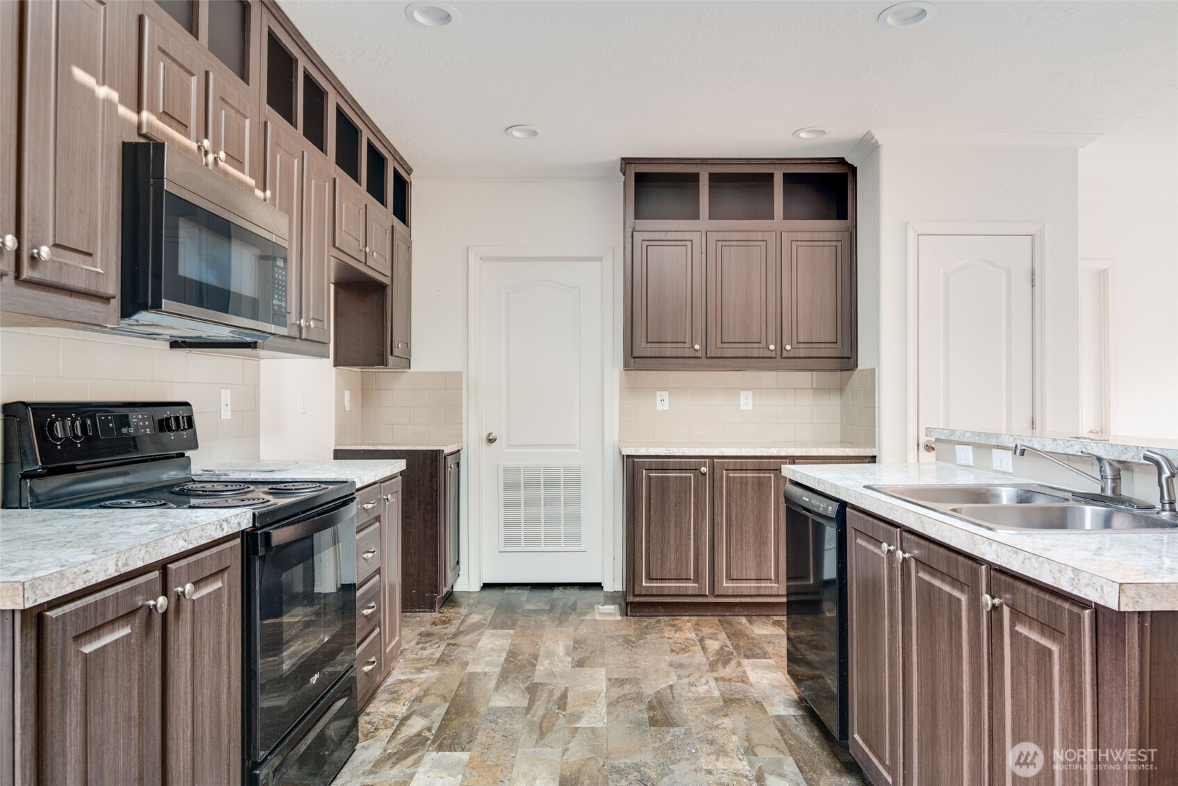 4322 Ocean Beach Highway Longview, WA 98632 - Photo 18 of 40 a kitchen with stainless steel appliances granite countertop a stove microwave and sink