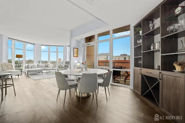 a view of a dining room with furniture and a book shelf