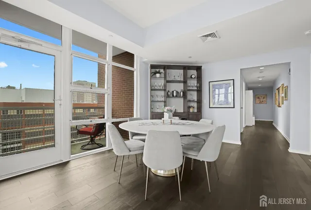 a view of a dining room with furniture and wooden floor