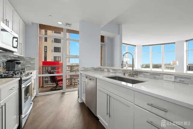a kitchen with stainless steel appliances granite countertop a stove and a sink