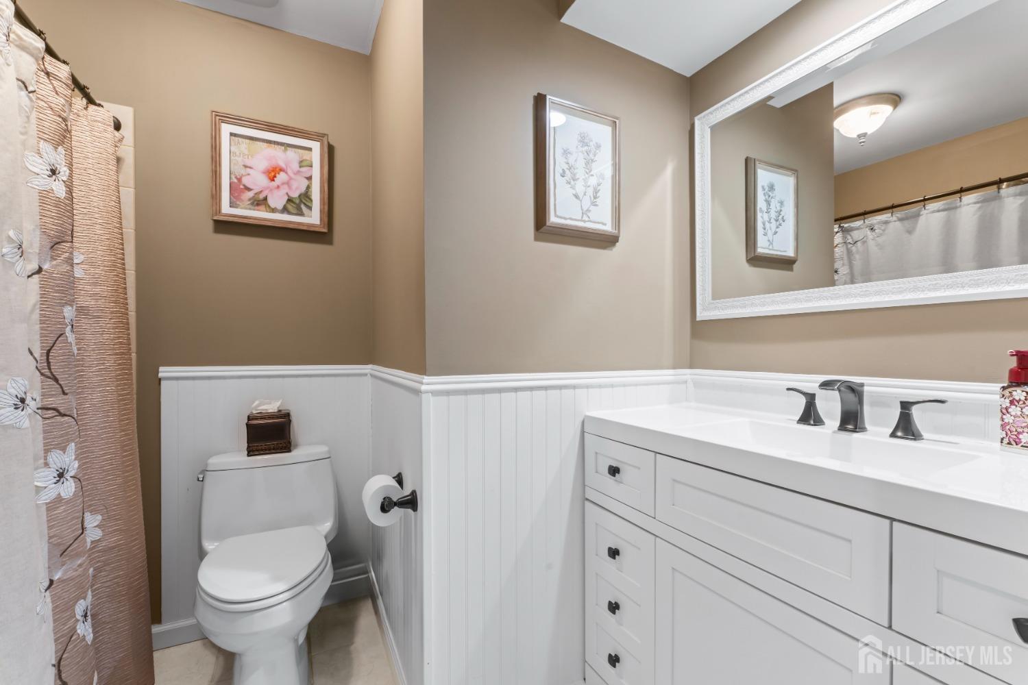 4 Whitman Road Morganville, NJ 07751 - Photo 18 of 45 a bathroom with a toilet sink and mirror