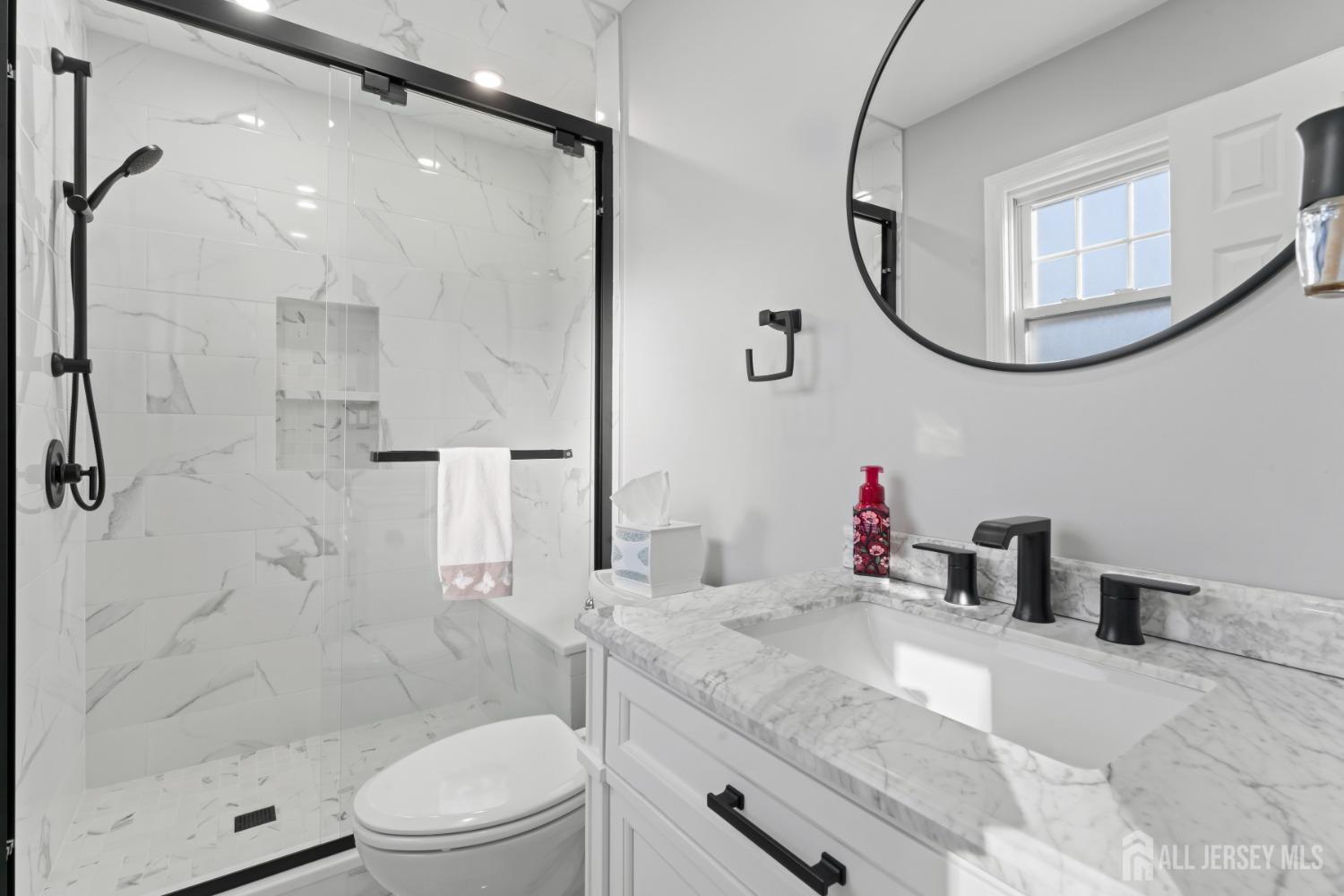 4 Whitman Road Morganville, NJ 07751 - Photo 21 of 45 a bathroom with a granite countertop sink a mirror and a shower