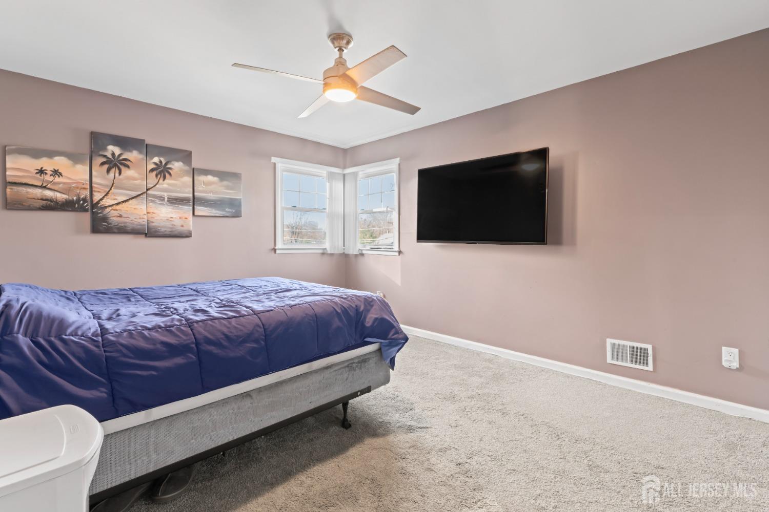 4 Whitman Road Morganville, NJ 07751 - Photo 25 of 45 a spacious bedroom with a bed and a flat screen tv