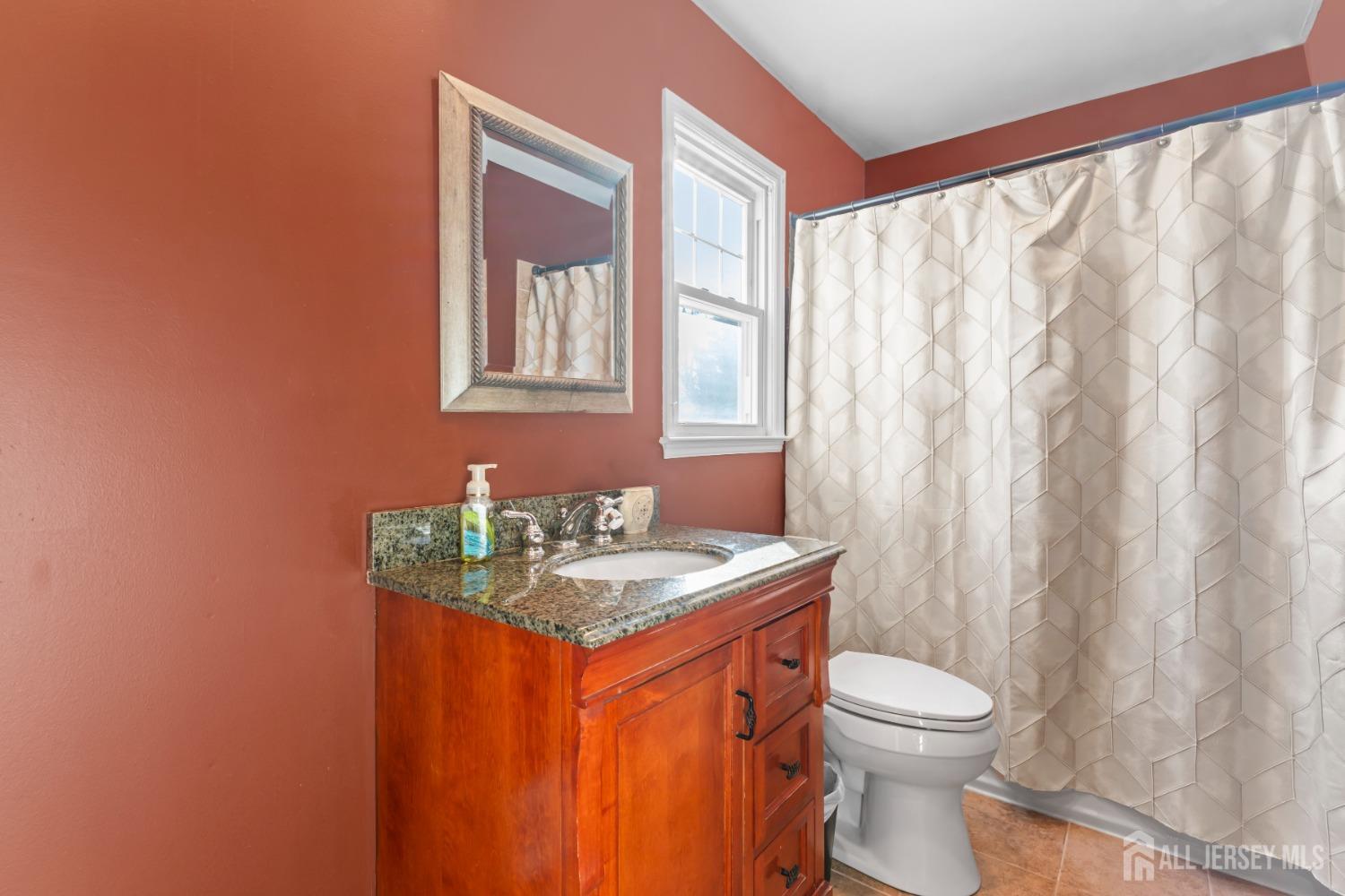 4 Whitman Road Morganville, NJ 07751 - Photo 26 of 45 a bathroom with a toilet sink and mirror