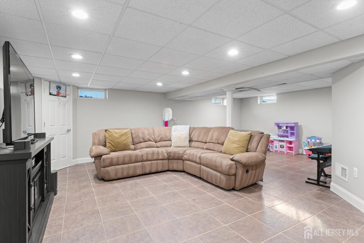4 Whitman Road Morganville, NJ 07751 - Photo 28 of 45 a living room with furniture and a flat screen tv