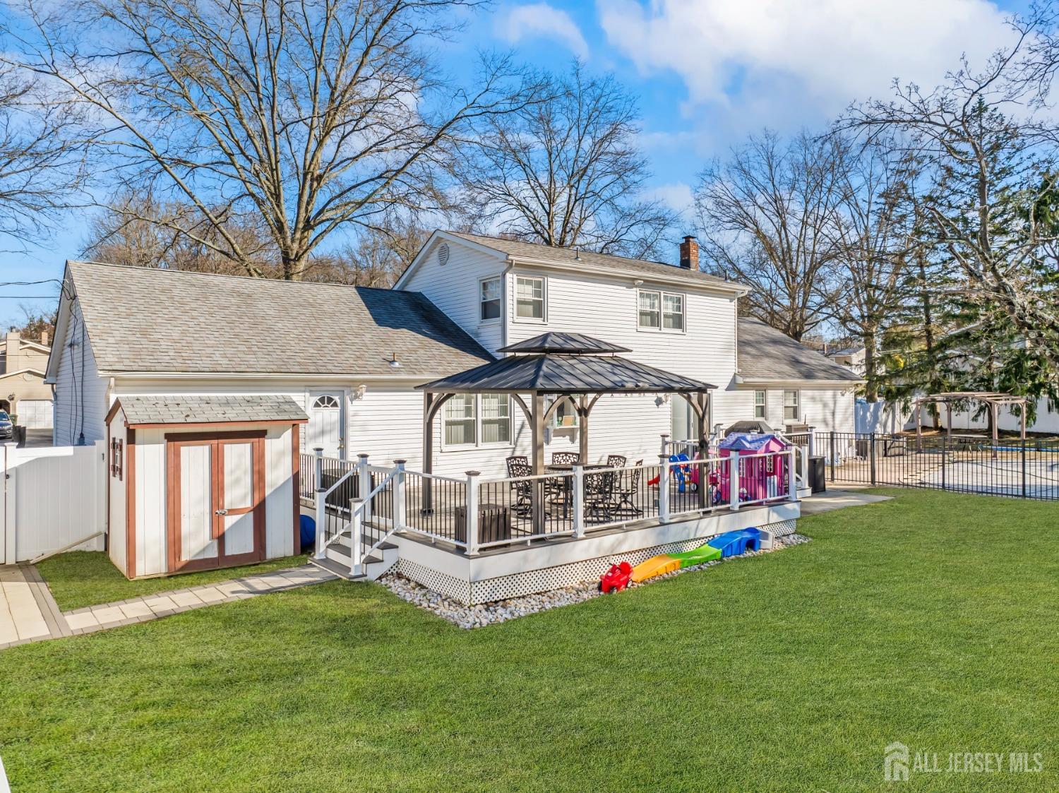 4 Whitman Road Morganville, NJ 07751 - Photo 32 of 45 a view of a house with a yard porch and sitting area