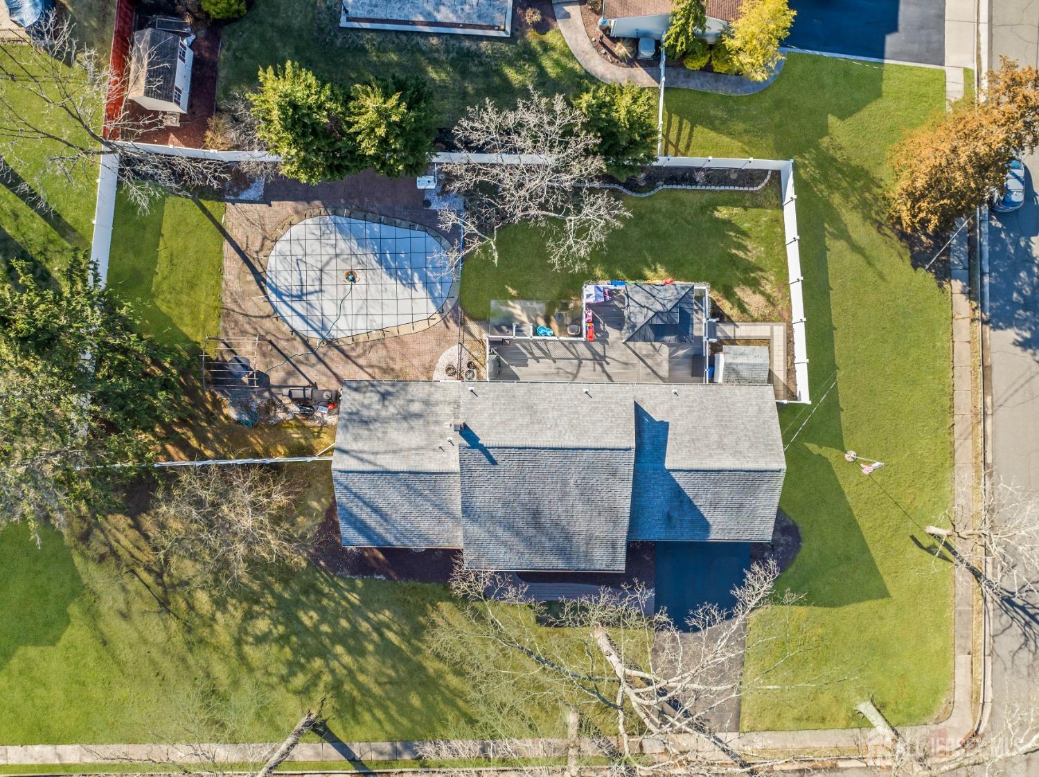 4 Whitman Road Morganville, NJ 07751 - Photo 39 of 45 an aerial view of a house with swimming pool and a garden
