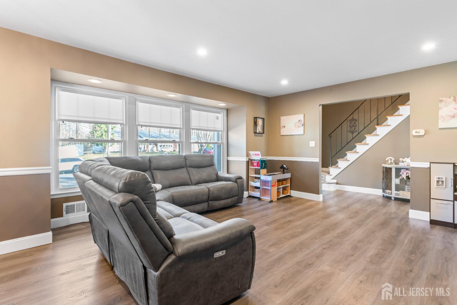 4 Whitman Road Morganville, NJ 07751 - Photo 7 of 45 a living room with furniture and a wooden floor