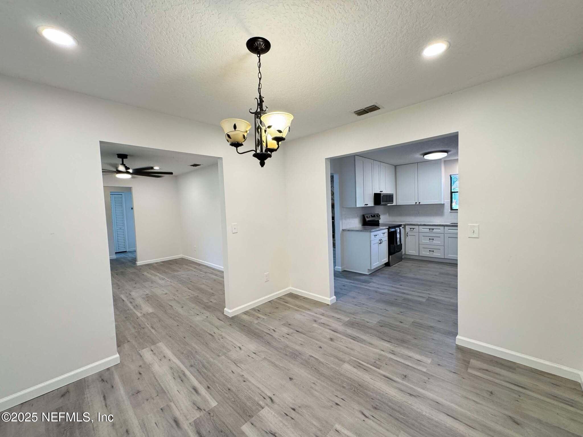 393 River Reach Road Fleming Island, FL 32003 - Photo 14 of 43 Din Rm to Living and Family rooms