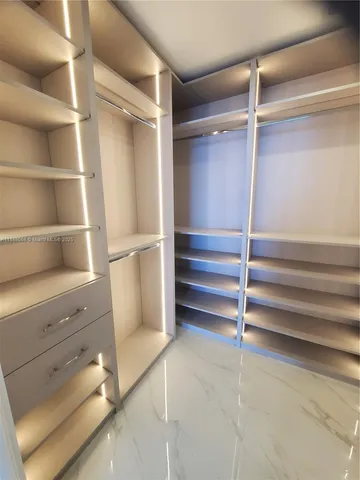 a view of room with a closet and racks