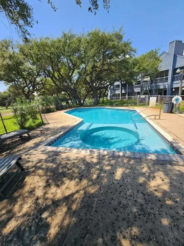 a view of a swimming pool with a yard