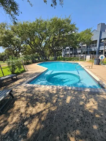 a view of a swimming pool with an outdoor space and seating area