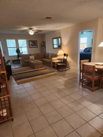 a living room with furniture and a lamp