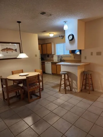 a large kitchen with a table and chairs in it
