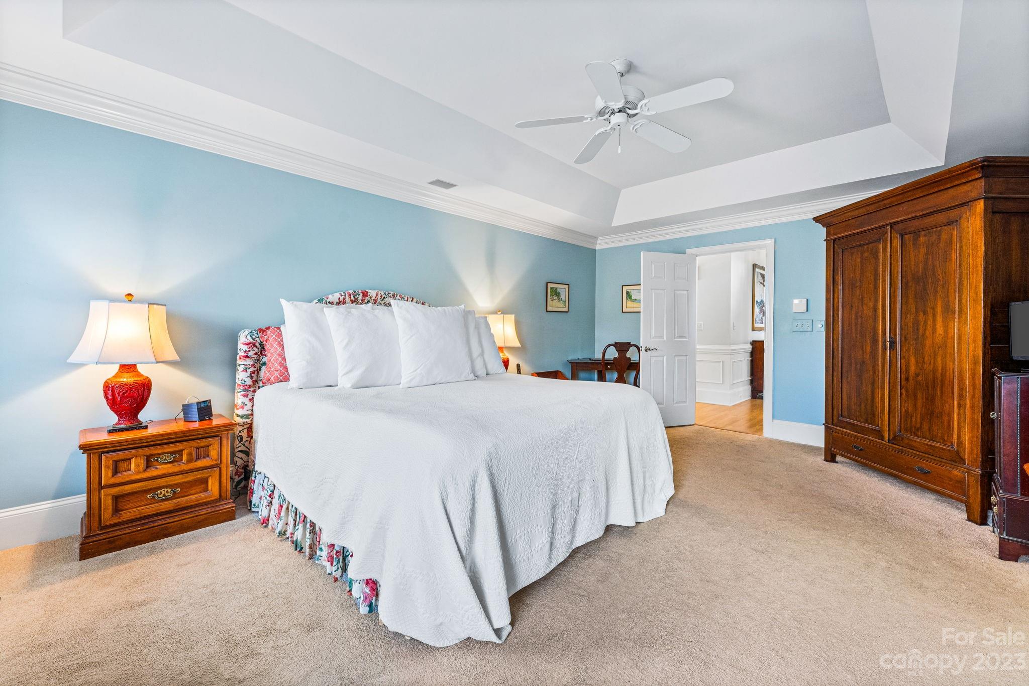 17318 Players Ridge Drive Cornelius, NC 28031 - Photo 23 of 48 a bedroom with a bed and a chandelier