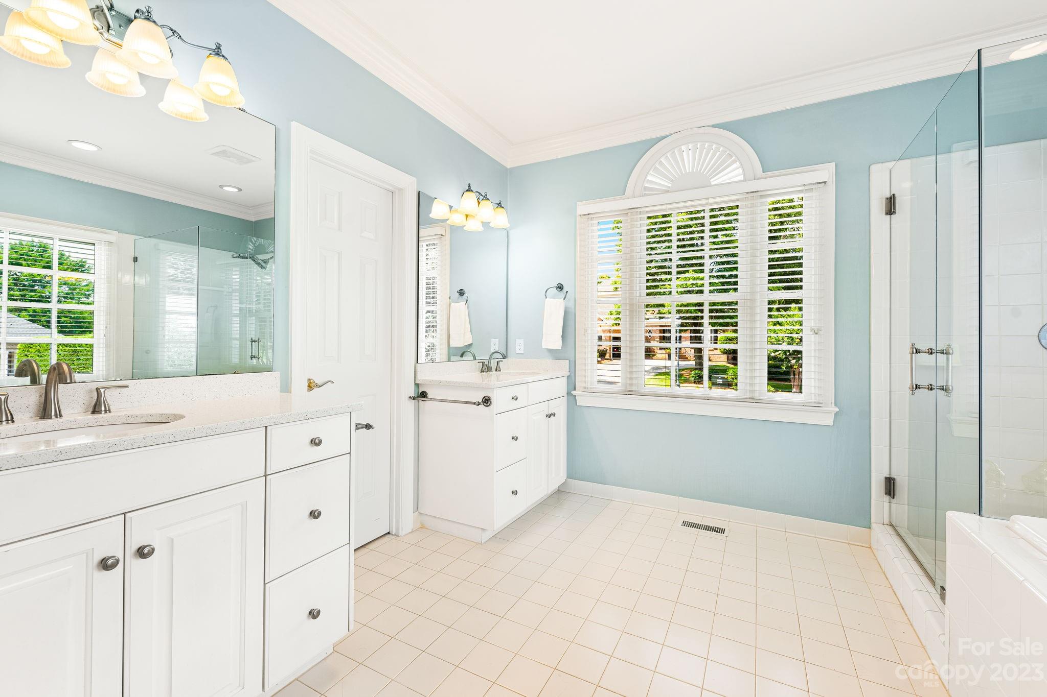 17318 Players Ridge Drive Cornelius, NC 28031 - Photo 25 of 48 a spacious bathroom with a granite countertop sink mirror and a bathtub