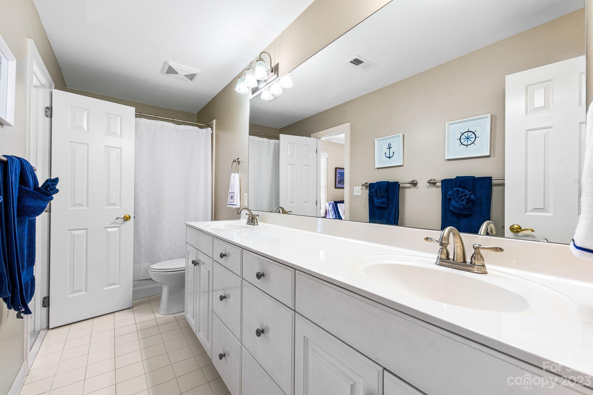 17318 Players Ridge Drive Cornelius, NC 28031 - Photo 30 of 48 a spacious bathroom with a double vanity sink mirror and double