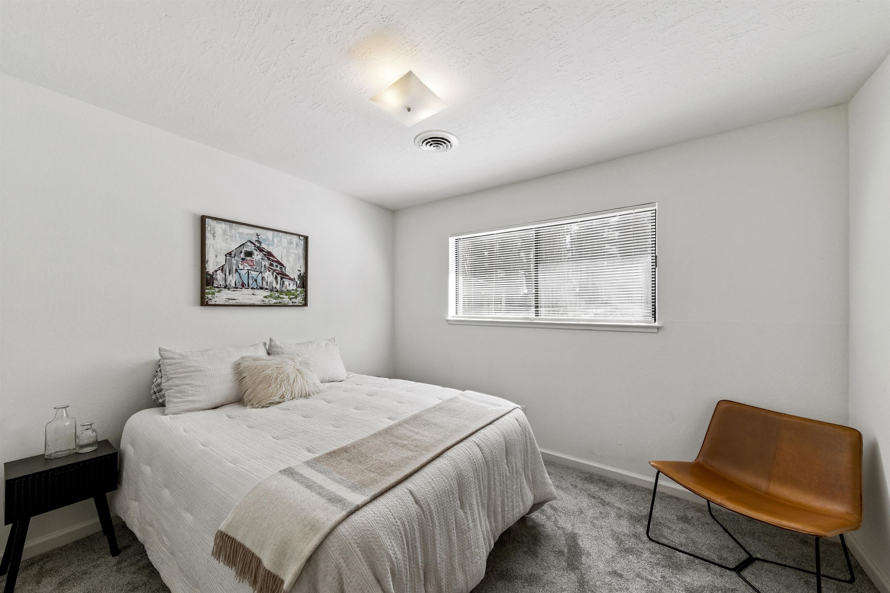 10895 Jeffery Pine Road Truckee, CA 96161 - Photo 22 of 25 a bedroom with a bed and a chair